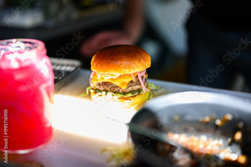 Close-up of a freshly prepared cheeseburger with beef patties, melted cheese and bun showcasing juicy gourmet street food ready to eat.