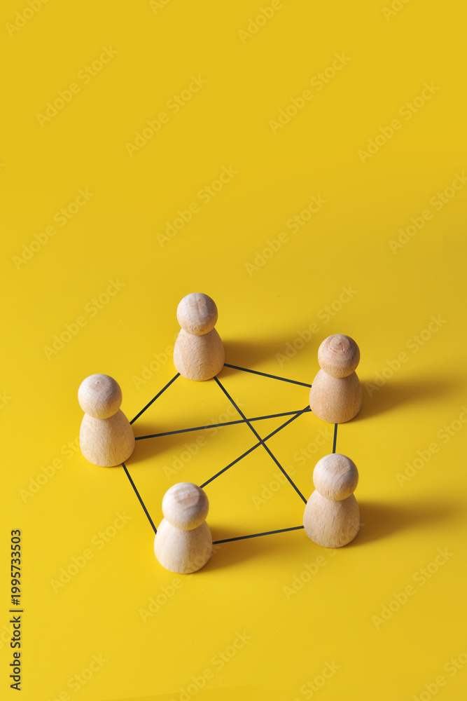 Obraz premium Connected team network with wooden figures, communication concept