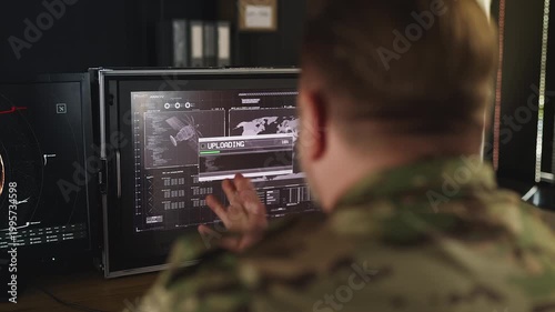 Male army officer uploading gathered data, sharing intelligence across agencies
