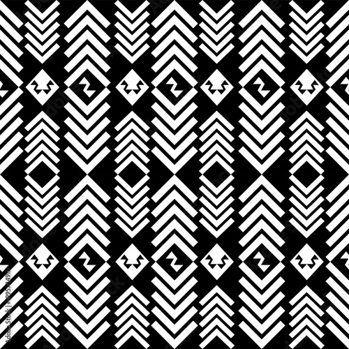 Seamless geometric pattern with black and white ethnic tribal motifs. Abstract vector background featuring repetitive diamond shapes, triangles, and square elements. Ideal for fabric print, wallpaper,