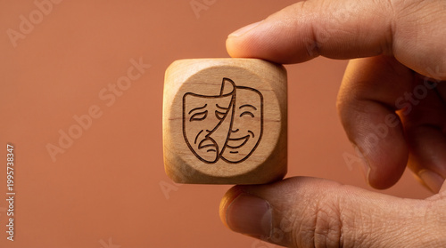 A wooden cube with a mask being removed revealing a real face icon on a warm terracotta background, symbolizing authenticity and genuine identity.