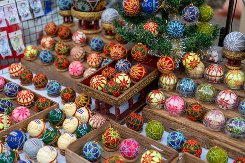 Colorful cotton ball lights with christmas patterns, decorative holiday ornaments, festive background with warm atmosphere, seasonal decoration for winter celebration concept