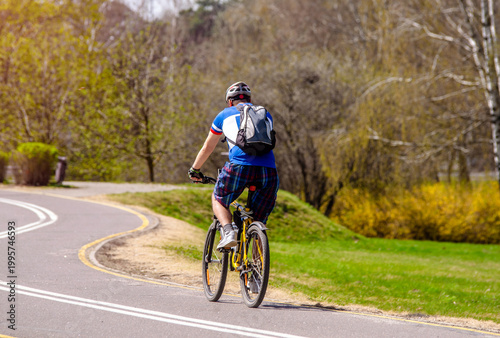 Cyclist ride on the bike path in the city Park
