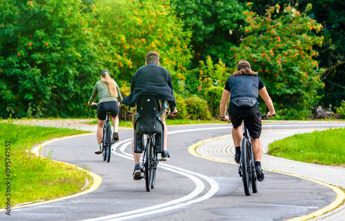 Cyclists ride on the bike path in the city Park
