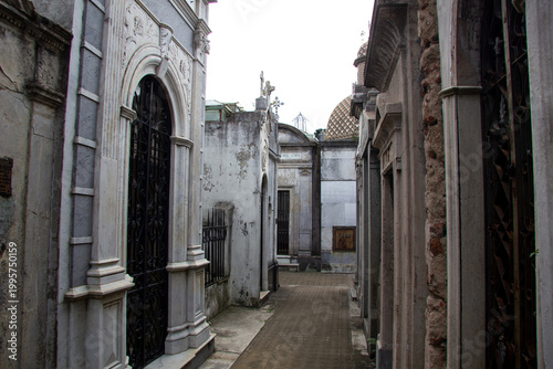 iconic Duarte family tomb in Recoleta Cemetery, where Eva Perón (Evita) is buried. black granite mausoleum is adorned with numerous bronze commemorative plaques dedicated to former First Lady.