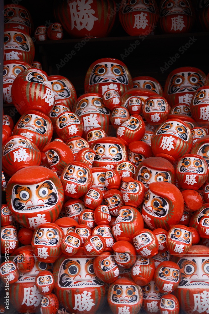 Fototapeta premium Red Daruma Dolls for Good Luck and Success – Traditional Japanese Lucky Charms Display