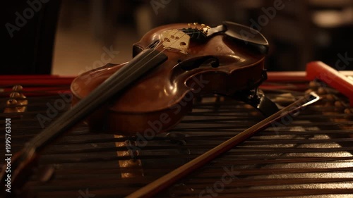Violin resting on marimba bars, intimate studio still life