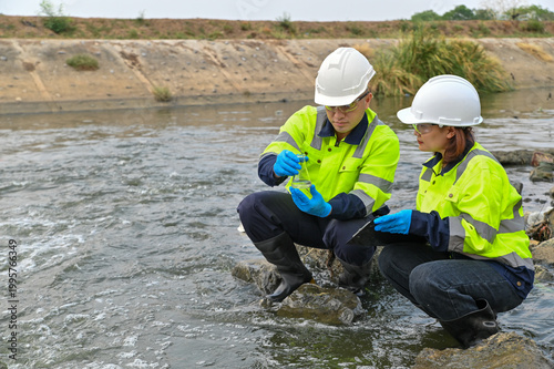 Scientists Performing Environmental Water Testing in Outdoor Setting