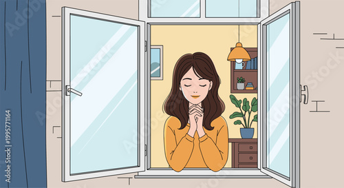 Young woman with closed eyes and folded hands praying or meditating while standing in her house window.