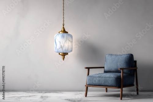 Minimalist room with blue chair and marbled pendant light.