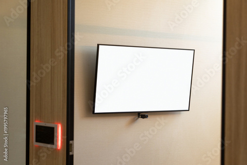 A wall-mounted blank digital screen in a modern interior, ideal for mockups or advertising, highlighting clean design, technology integration, and contemporary architectural aesthetics.