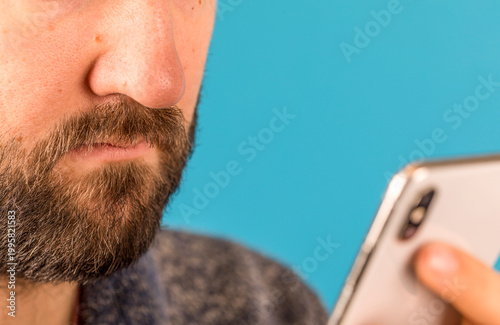 A close-up of a man holding...