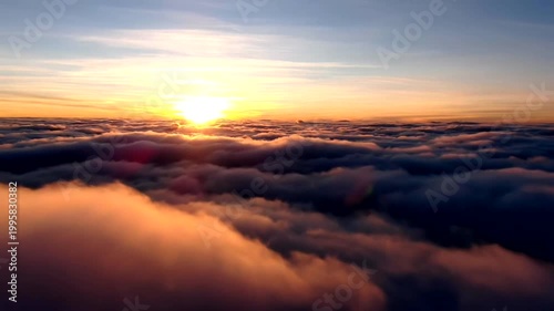 Stunning aerial view of golden sunset above the thick cloud layer.