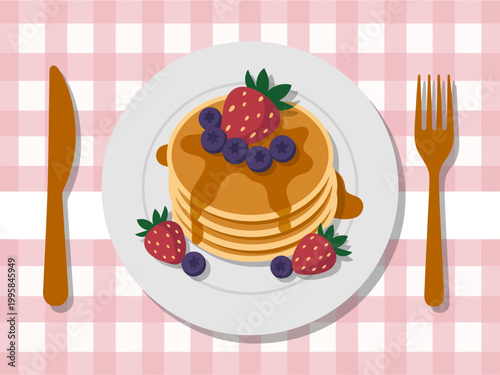 Stack of golden pancakes with strawberries and blueberries, drizzled with syrup, served a white plate with cutlery