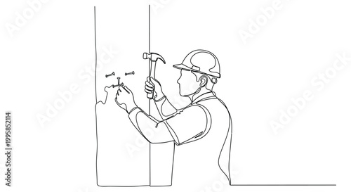 A construction worker wearing a hard hat hammers a nail into a wooden beam indoors.