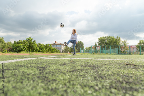 Woman kicking ball with her feet