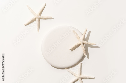 Konstfotografi Minimalist product presentation scene made with round white podium surrounded by starfishes on clean background