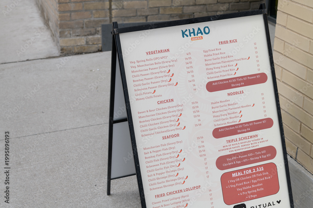 Fototapeta premium sidewalk A-frame with menu for Khao Hakka, restaurant, located at 37 Sherbourne St inside The East Lofts Condos, Toronto
