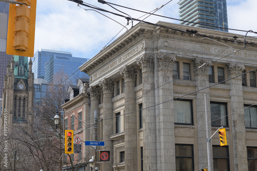 Fototapeta premium exterior of historic bank branch of the Canadian Bank of Commerce, designed by Darling and Pearson, 1907, at 144 King St E, at Jarvis St, Toronto