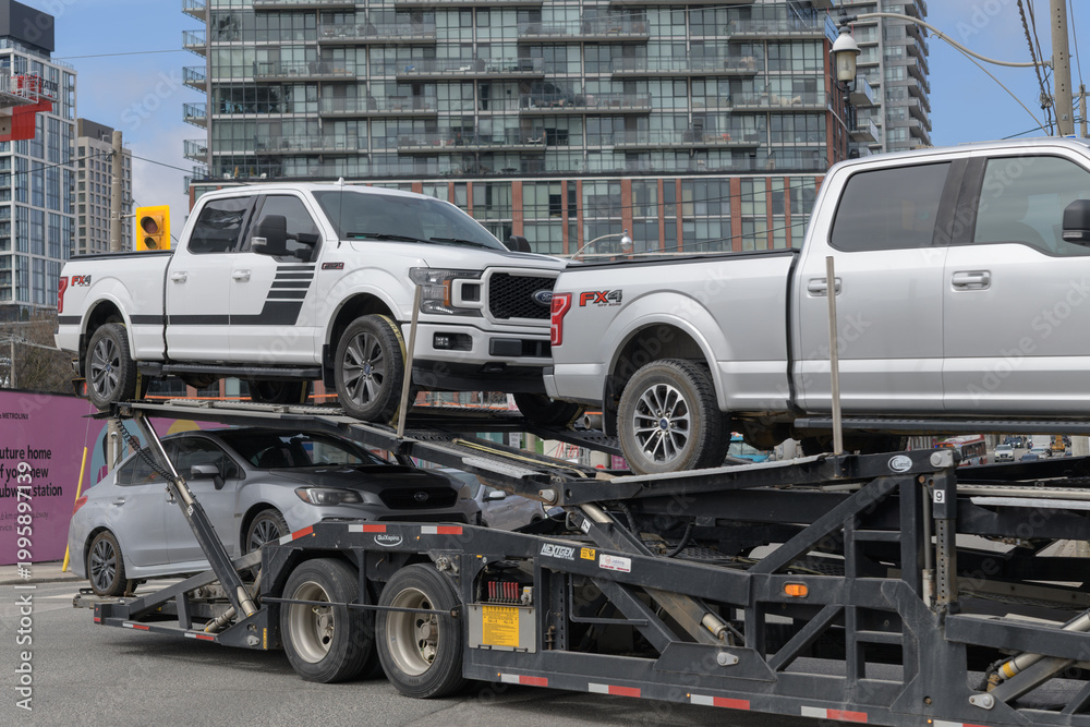 Fototapeta premium multi-level auto transporter turning on Front St E at intersection of Parliament St, Toronto
