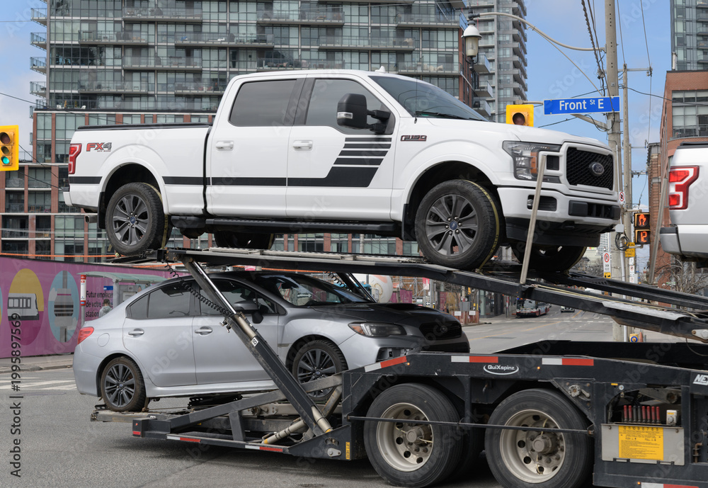 Fototapeta premium multi-level auto transporter turning on Front St E at intersection of Parliament St, Toronto