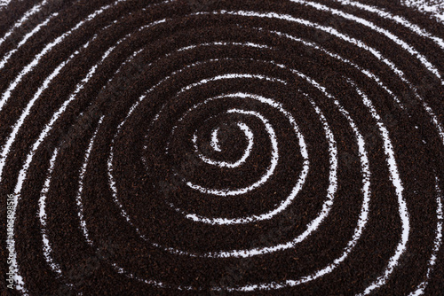 The spiral patterns formed by the black tea powder