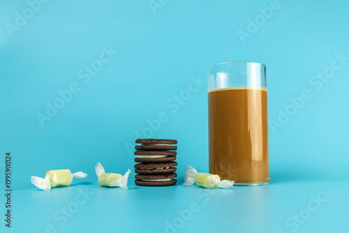 A coffee drink contained in a glass on a plain background