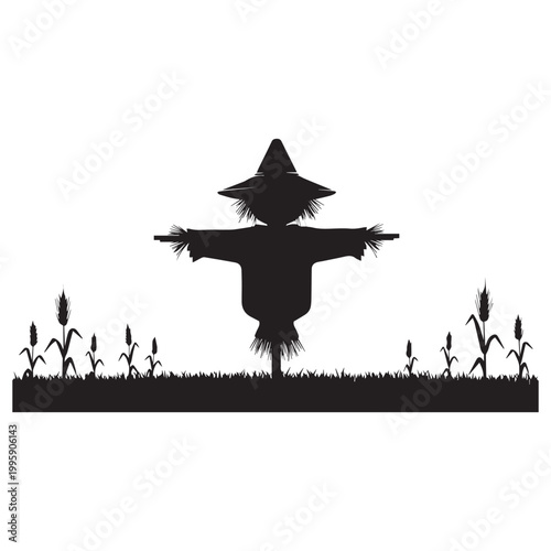 Silhouette of a scarecrow in a field with corn stalks