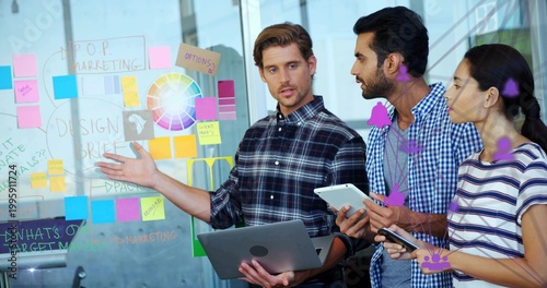 Foto Gesturing presenter wearing plaid shirt holding laptop and pointing at glass wal