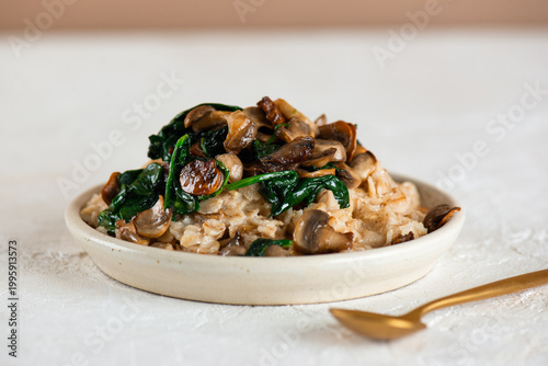 Savory oatmeal with sautéed mushrooms and spinach, vegan, gluten free. Healthy breakfast.