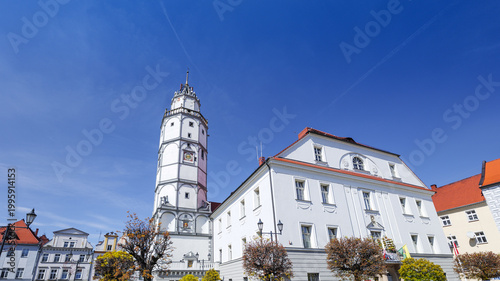 Town Hall in Paczków, Poland .Visit to a historical town square with a tower and buildings under a clear blue sky in Poland during the daytime