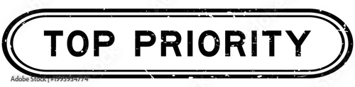 Grunge black top priority word rubber seal stamp on white background