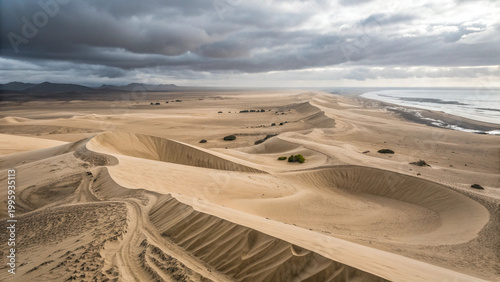 Aerial drone view of desert sand dunes with geometric patterns and shadows