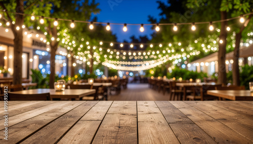 Cozy outdoor restaurant patio with glowing string lights and empty wooden table at twilight.
