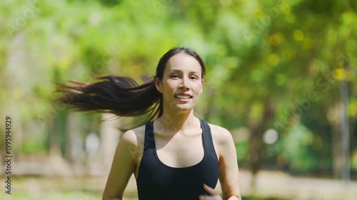 Young athletic woman running in park during outdoor workout, healthy lifestyle and fitness training concept.