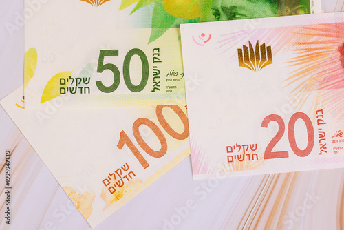 Tableau sur toile Three types of New Israeli shekel money are laid out on surface