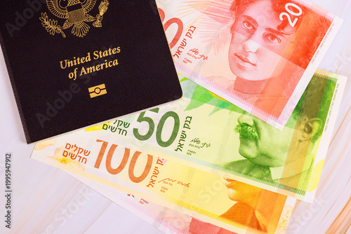 Foto United States passport next to different New Israeli shekel banknotes on table, preparation for travel