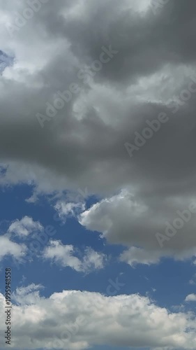 A timelapse of fluffy black clouds during stormy weather in winter. This footage captures dramatic winter conditions, showcasing the intensity of the storm. Vertical Dark cloud sky thunder storm cloud