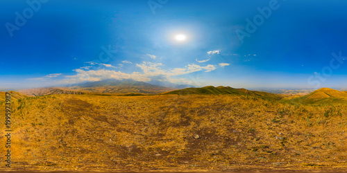 360 degrees panoramic view of golden dry grass field and rolling hills