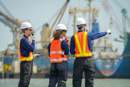 Construction crew collaborating at port industrial site photo daylight side view teamwork in action