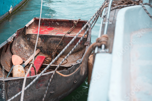 Rusty Metal Dinghy Moored in Turquoise Water