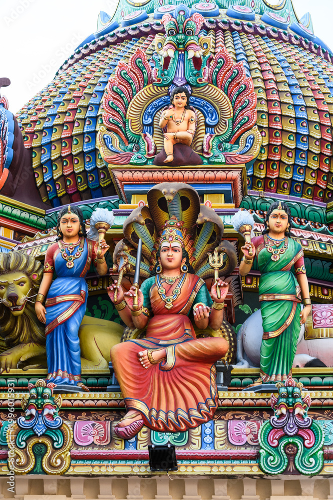 Fototapeta premium Detail of the exterior of the Sri Mariamman Temple, Singapore's oldest Hindu temple, featuring colorful, plaster sculptures of Hindu deities and other ornamental figures and objects.