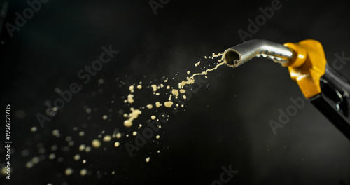 Photography Gasoline droplets spraying from fuel nozzle on dark background, minimal остатky fuel flow