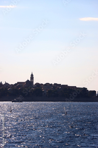 Small town Korcula, on island Korcula, Croatia, illuminated by back light. Summer travel destination.