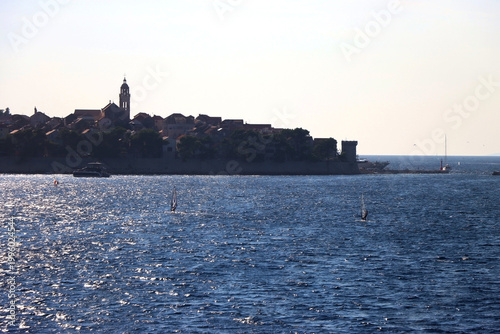 Small town Korcula, on island Korcula, Croatia, illuminated by back light. Summer travel destination.