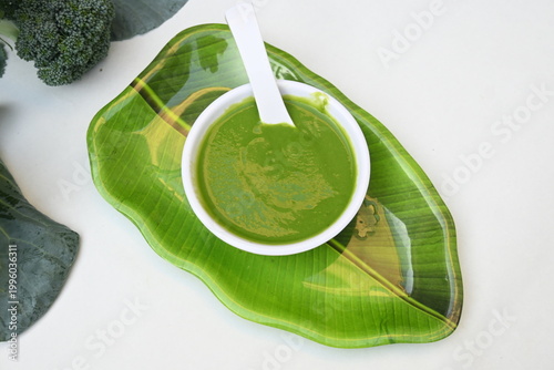 Broccoli soup on white background. It is just as nutritious as it is visually appealing. Crafted into a perfectly smooth, silky, and emerald-green puree, it delivers the fresh taste of green vegetable