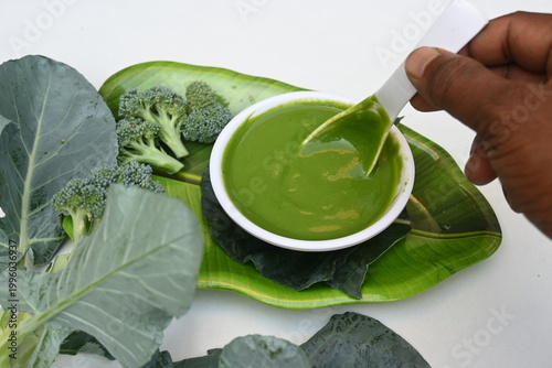 Broccoli soup on white background. It is just as nutritious as it is visually appealing. Crafted into a perfectly smooth, silky, and emerald-green puree, it delivers the fresh taste of green vegetable