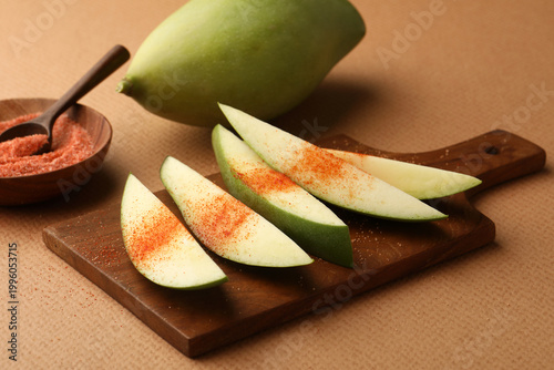 Bild auf Leinwand Raw Mango with sliced pieces with chilli powder and salt