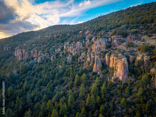 Fotografi Vertical volcanic rock formations rising from a canyon floor