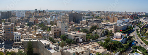 An aerial view of Tripoli, Libya, overlooking buildings and roads, looking in a westerly direction.